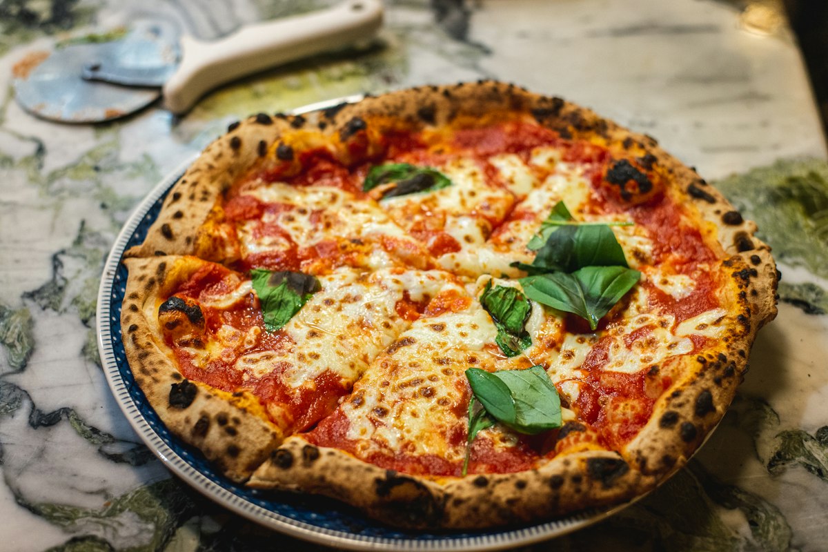 Classic Neapolitan-style margherita pizza with fresh basil, served at Merchant of Venice Leicester
