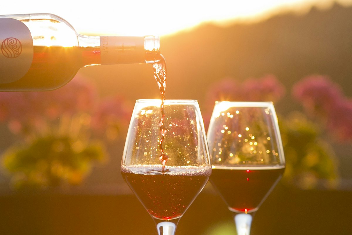 Two glasses of red wine poured at golden hour, a romantic touch to date night dining in Leicester