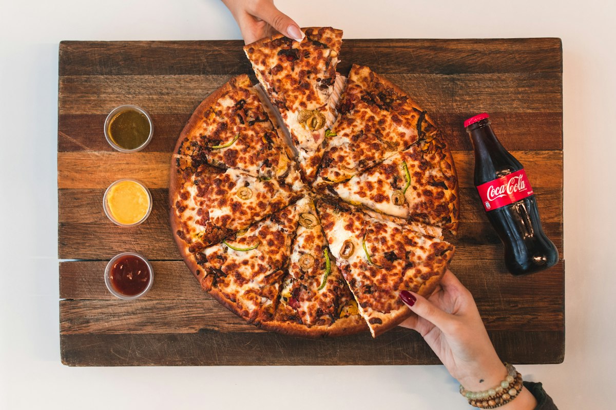 Sharing pizza slices at the table, a kid-friendly meal at Merchant of Venice Leicester