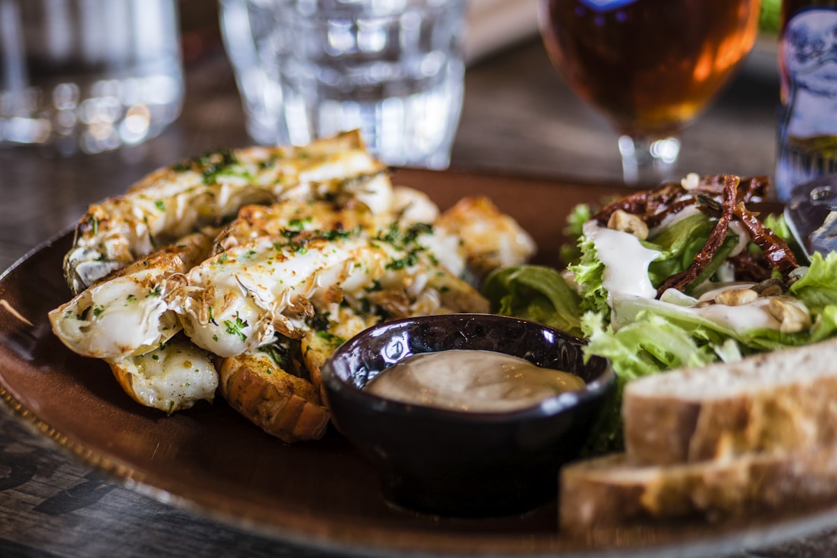 Shared starter plates and garlic bread on a table, ideal for family-style dining at Merchant of Venice
