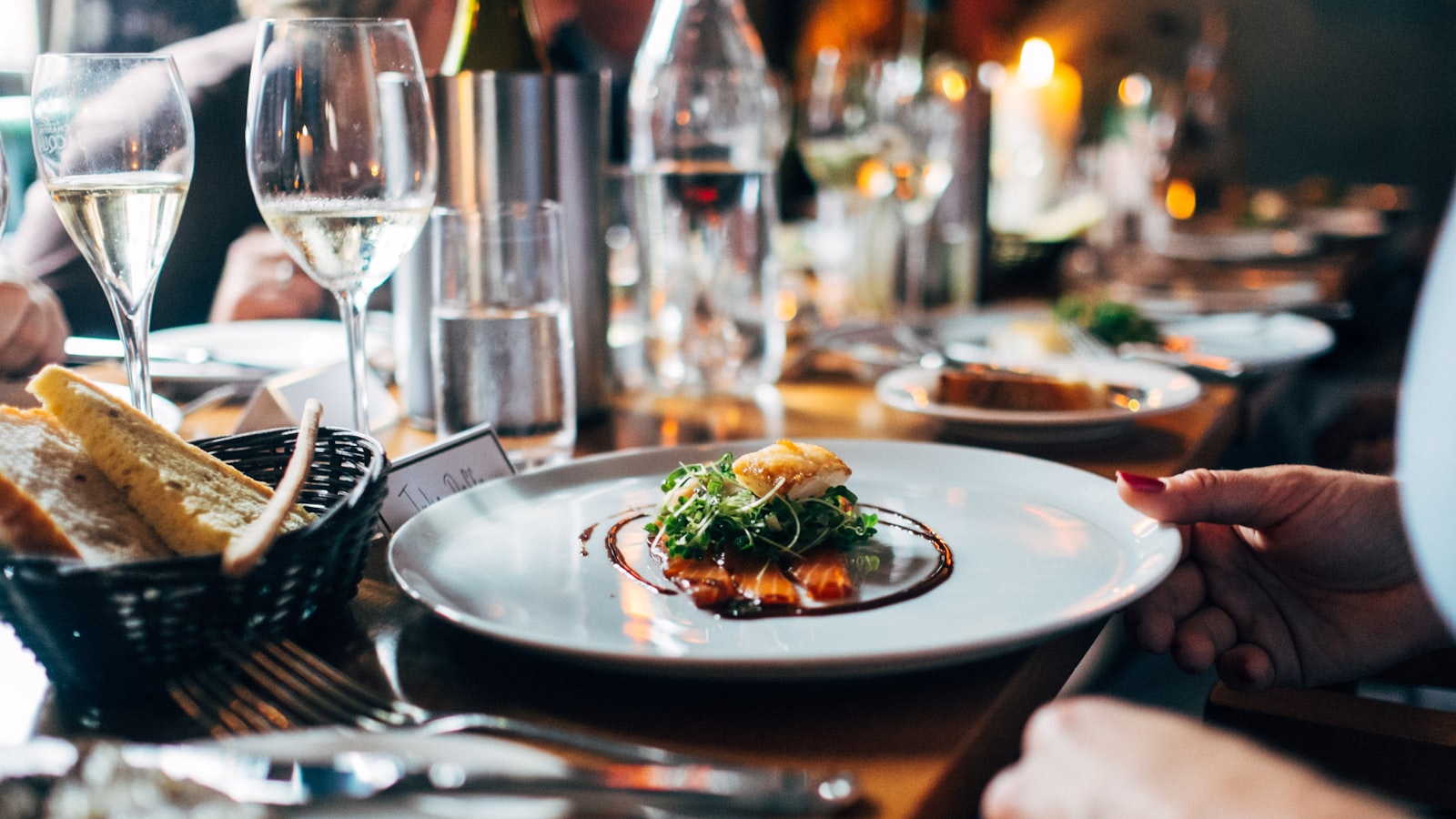 Elegant pre-theatre dinner table set with wine glasses and a plated Italian dish at Merchant of Venice Granby Street Leicester