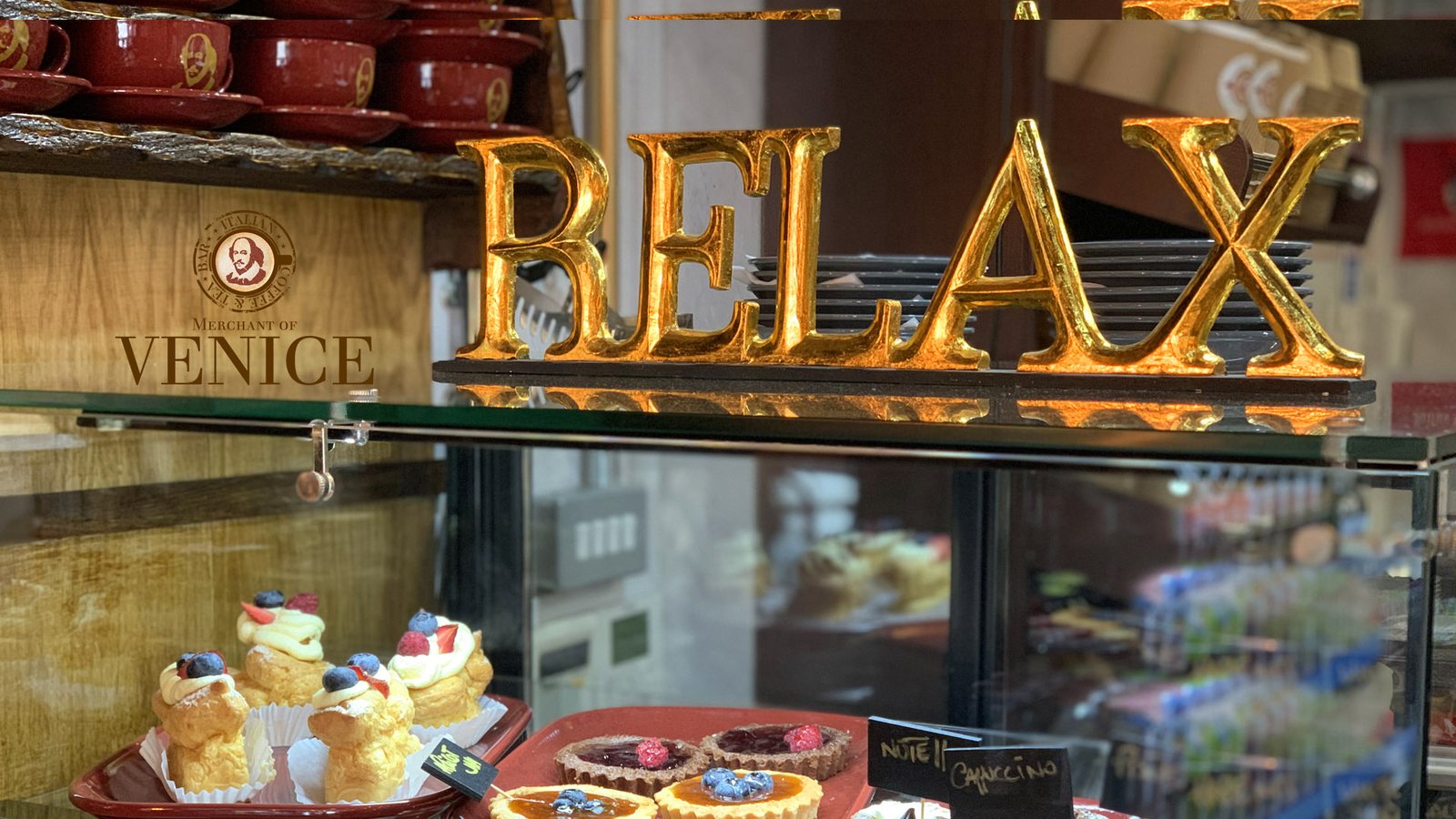 Italian pastries and a Relax sign on the counter at Merchant of Venice